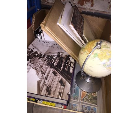 A box of memory books and a small terrestrial globe 