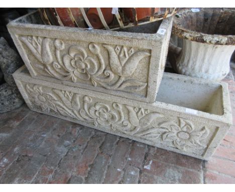 Rectangular cast concrete garden planter together with a similar smaller planter 