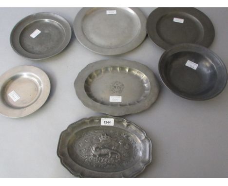 Seven pewter plates, dishes and bowls, one decorated with a crown and lizard 