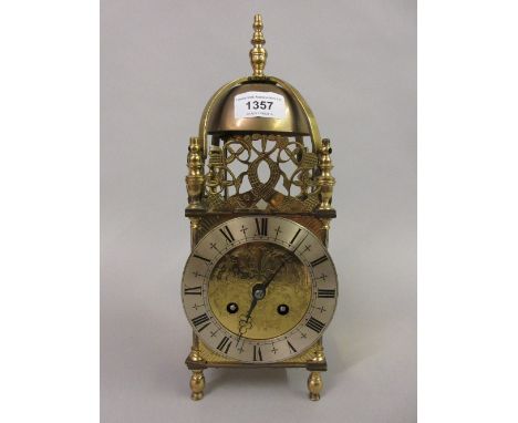 Gilt brass lantern type clock with silvered dial and Roman numerals, the two train Japy Freres movement stiking on a bell 
