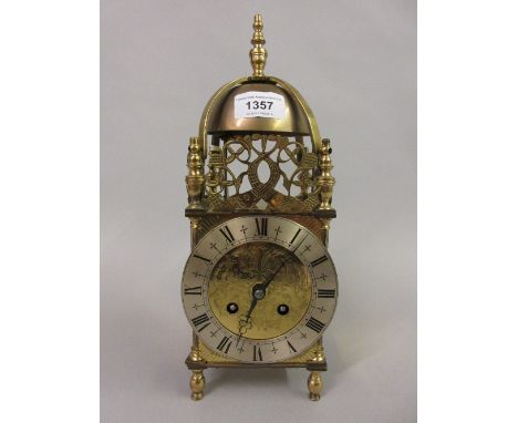 Gilt brass lantern type clock with silvered dial and Roman numerals, the two train Japy Freres movement stiking on a bell 