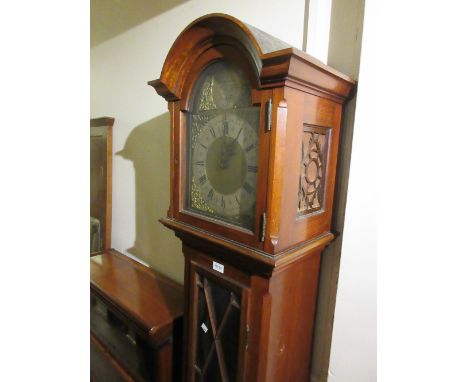 Mid 20th Century mahogany longcase clock with an arched hood above glazed door, raised on bracket feet, the silvered and bras