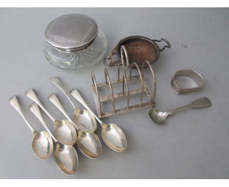 Silver toast rack, tea strainer, six teaspoons, napkin ring, silver mounted dressing table jar and plated salt spoon 