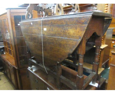 18th Century oak oval gate leg dining table with single end drawer having later knob handle raised on turned supports, closed