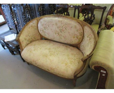 19th Century gilt sofa with bird and floral upholstery and carved decoration, raised on turned reeded and fluted front suppor