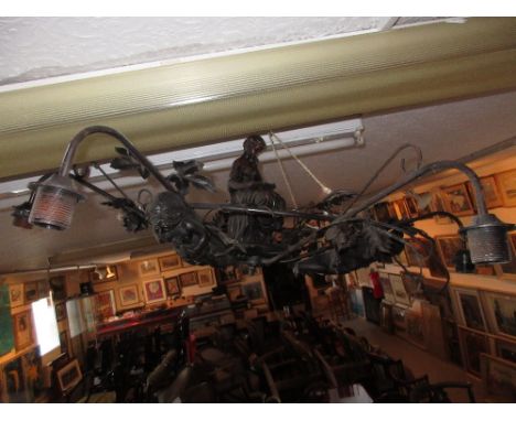 Large brown patinated metal six branch chandelier mounted with a figure reading and cherubs 
