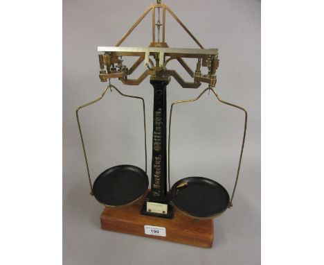 Pair of unusual balance scales in lacquered brass and cast iron, inscribed F. Sartorius on a mahogany stand, 14.5ins high 
