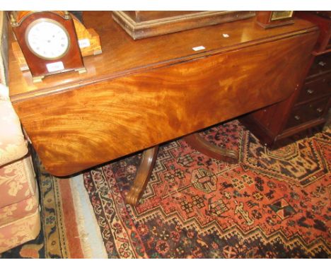 19th Century figured mahogany sofa table having opposing end drawers, one fitted with writing slope raised on a reeded turned