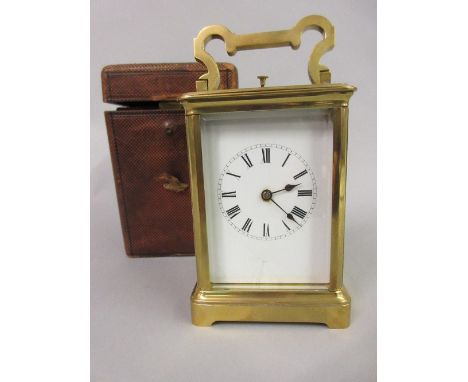 Large brass cased carriage clock, the enamel dial with Roman numerals and two train movement striking on a gong with repeat f