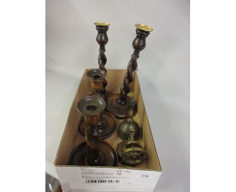 Two pairs of 1930's wooden candlesticks, a nutcracker in the form of a ships wheel and a brass bell 