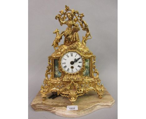Reproduction French gilt brass figural mantel clock mounted on a marble platform base 