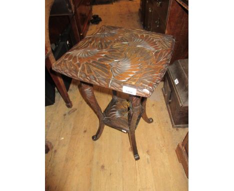 Floral carved square two tier occasional table with shaped supports and a child's ladder back rush seat chair 