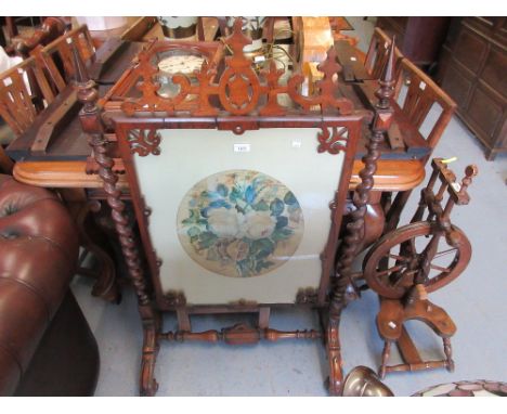Victorian rosewood firescreen of Gothic design with barley twist uprights and scroll shaped feet 