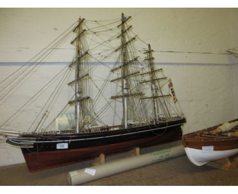 Wooden scale model of the Cutty Sark together with a scale model of an America's Cup yacht and an anchor sloop 