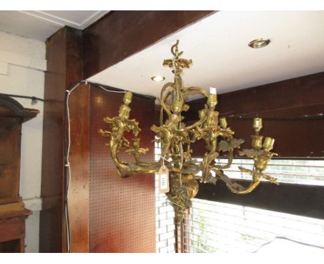 Late 19th or early 20th Century gilt brass twelve light chandelier adapted for use with electricity, 26ins high 