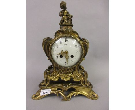 19th Century French ormolu mantel clock with cherub surmount, the enamel dial with Arabic numerals inscribed Petit, Rue Monge
