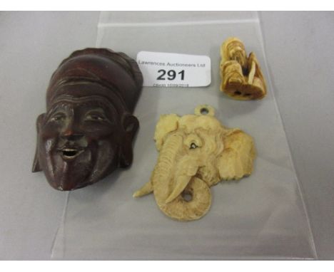 Small 19th Century carved ivory netsuke, 19th Century carved ivory elephant pendant and a small native carved hardwood mask 