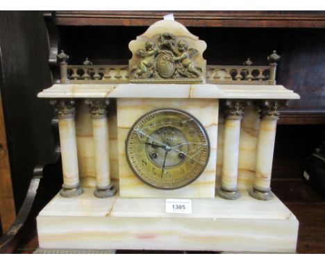 Late 19th or early 20th Century French beige onyx and gilt metal mounted mantel clock with a gallery top above a circular gil