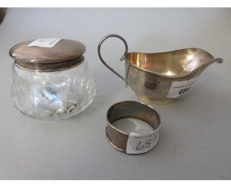 Birmingham silver cream jug, silver napkin ring and a silver topped dressing table jar 