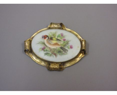 19th Century Royal Worcester oval porcelain plaque painted with a bird in a thistle bush, gilt metal mounted as a brooch 