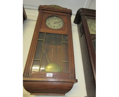 Early 20th Century Continental oak cased wall clock with a gilt metal torch and quiver surmount, the circular silvered twenty