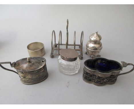 Silver toast rack, silver mounted glass inkwell, napkin ring and three various silver condiments 