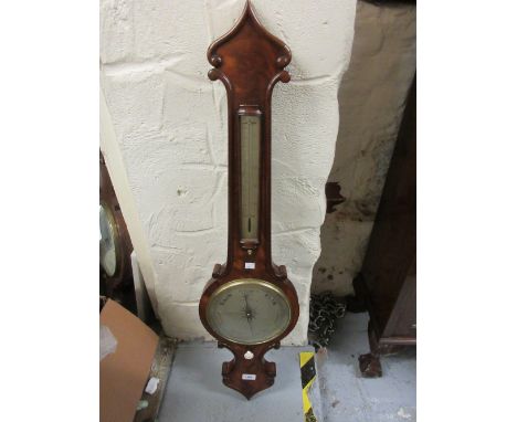 19th Century figured mahogany wheel barometer with removable thermometer having bowed glass and silvered barometer dial inscr