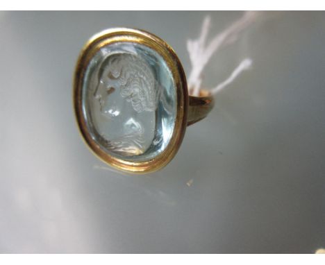Yellow metal ring set with a blue glass intaglio portrait 