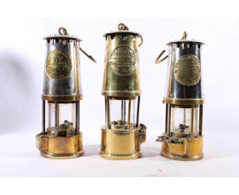 Three miner's safety lamps including an Eccles Protector Lamp and Lighting Co Ltd type 6, a similar model type GR6S and anoth