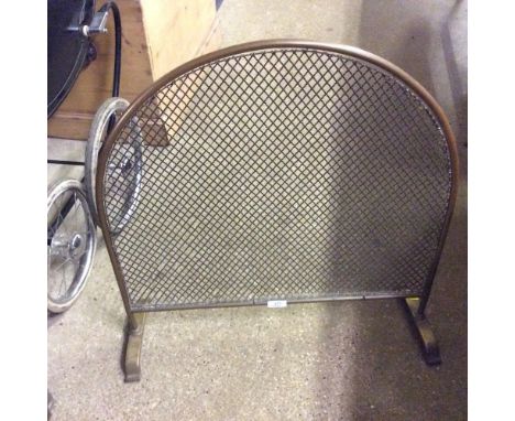 A brass and wire work fireguard 