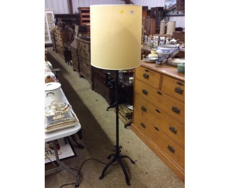 A wrought iron standard lamp and shade 