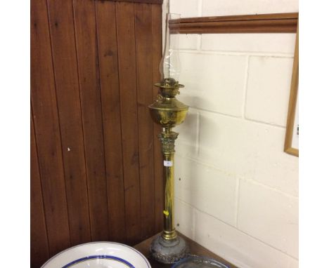 A large brass Corinthian columned oil lamp 