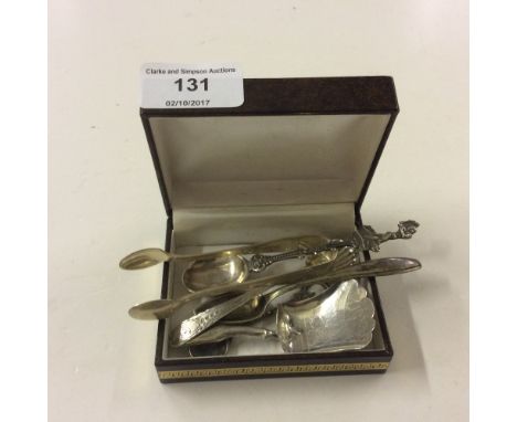 A box of silver items to include caddy spoon and sugar tongs