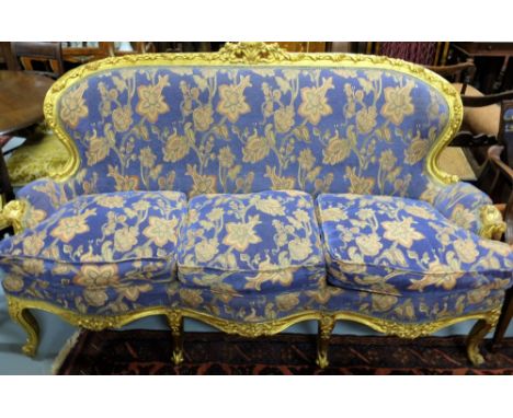 Carved gilt wood decorative 3-seater sofa, covered with blue floral fabric, on 4 front cabriole shaped legs, 70”long, 