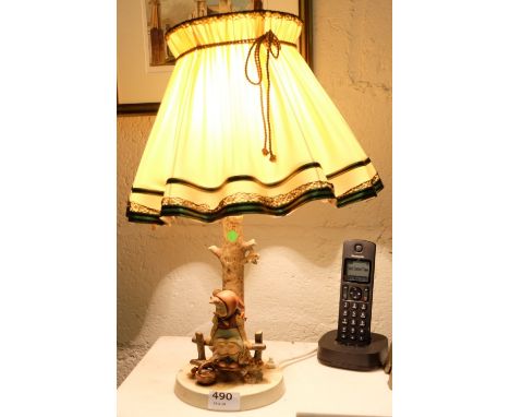 Hummell Table Lamp – figure of a girl seated on a fence, electric with a fluted shade, 16”h