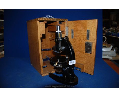 An Olympus Microscope in fitted Oak case, together with five lenses