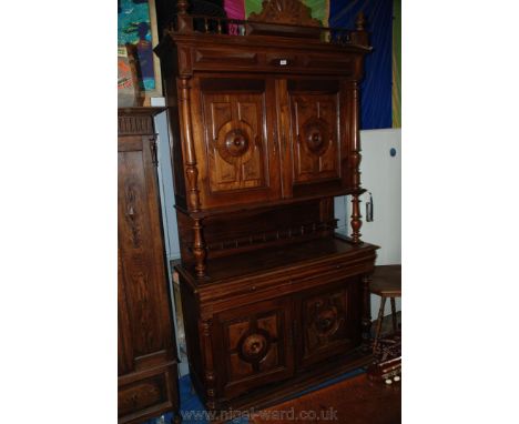 A French Mahogany Dresser, having carved pediment top on spindle turned support gallery, the top pair of opposing doors with 