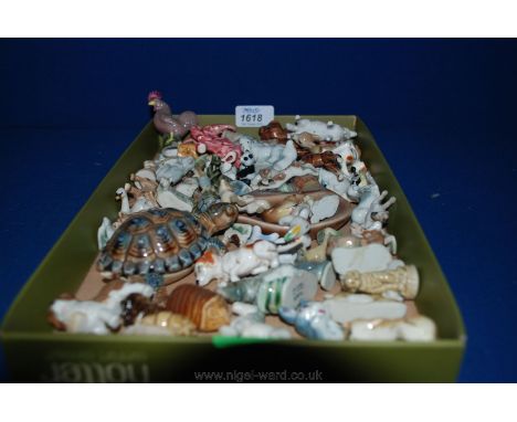 A quantity of small china animals, some being Wade including  lion, boar, sea lion, rhino, pink elephant, etc.