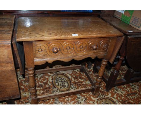 A reproduction double drop leaf Side Table, having rectangular top with rectangular leaves to the ends, carved front frieze d