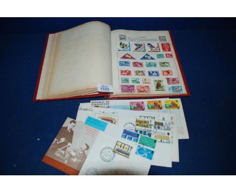 An Universal Stamp album with stamps including eight first day covers