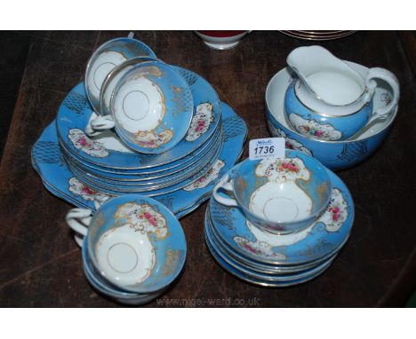 A seven place setting Teaset pattern no. 7938 decorated with panels of flowers and gold scrolls on blue ground including cups