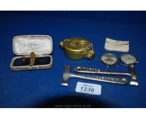 A small handmade model of an aircraft made into a Brooch, toffee hammers, directional Compass, sovereign Pouch and two gent's