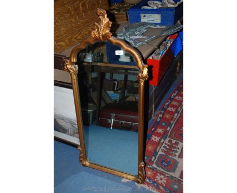 A scalloped shape top Mirror 15 1/4" x 33" with fauna finial 