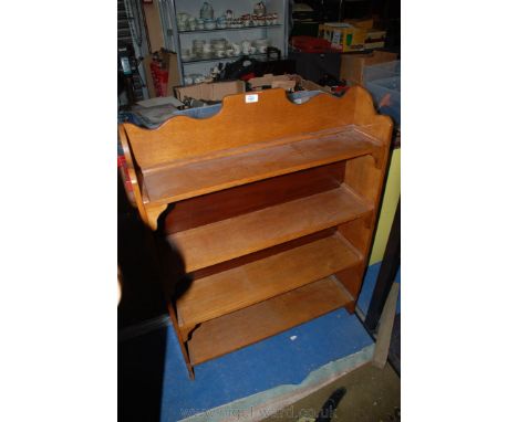 An Oak four shelf Bookshelf with shaped top