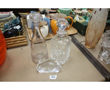 A square cut glass Decanter and Stopper, another decanter and stopper and a Paperweight in the form of a Seal.