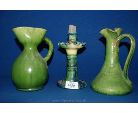Two green pottery Jugs along with a green, blue and yellow Candlestick from Belgium. 