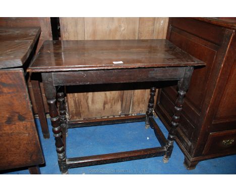 A late 18th /early 19th c. Oak Occasional Table having moulded edge four plank top, plain frieze, standing on urn turned orna