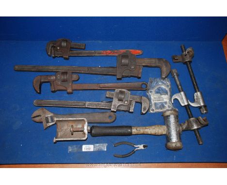 A box of four sets of Stilsons, an adjustable spanner, a soft face hammer, pullers and a suspension coil spring compressor.