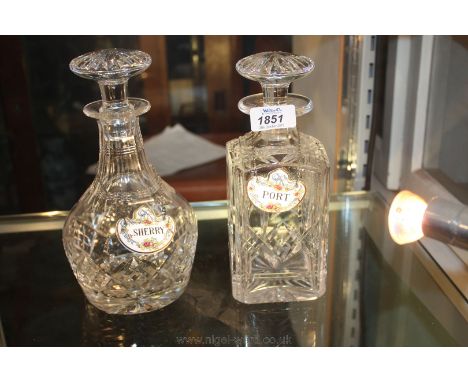 A square cut crystal Whiskey Decanter and a club shaped Decanter, each having a ground glass stopper and sold with two porcel
