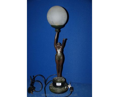 An art deco style lamp in the form of a dancer holding a white crazed globe on circular base.  26 1/2'' tall including base